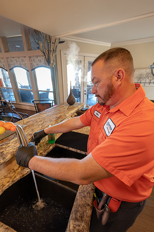 tech work on kitchen sink